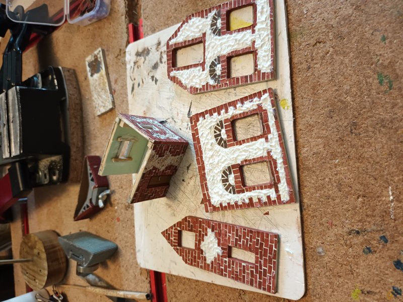 Individual structures glued together, with windows fitted before assembling